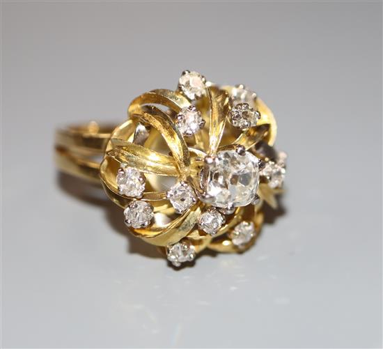 A modern 18ct and diamond set raised cluster dress ring, size N, gross 8.6 grams.